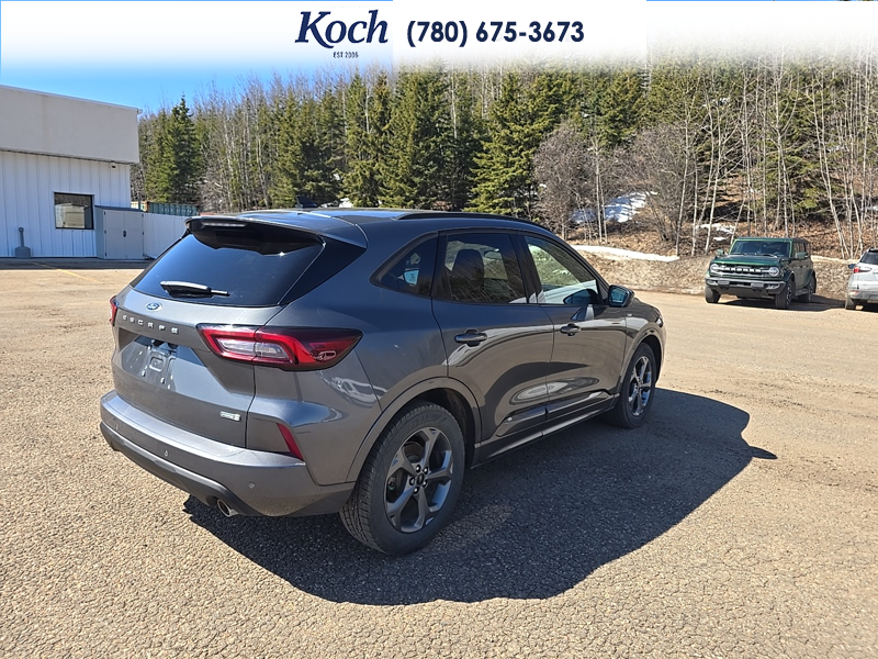 USED 2023 Ford Escape ST-Line Select - Carbonized Grey Metallic Exterior / EBONY VINYL/ RED STITCHING Interior - $29,995 - Stock #A26085A - VIN 1FMCU9NZ8PUA93510 - Photo 2